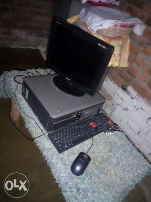 Black Flat Screen Monitor; Gray Computer Tower; Black Corded