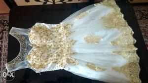 Beautiful white dress with golden embroidery.