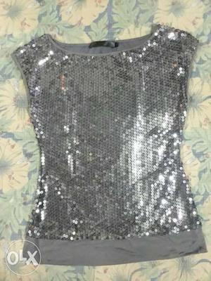 Its a silver bling top. Party wear. Colour-