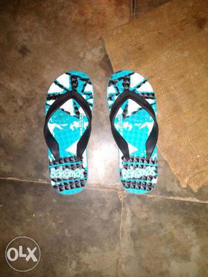 Pair Of Blue Black And White Flip Flops