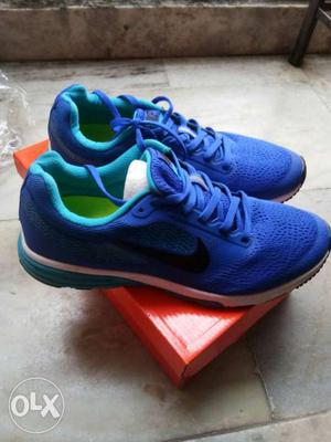 Pair Of Blue Nike Running Shoes On Box