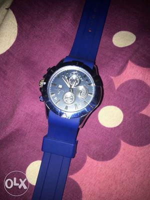 Round Silver Chronograph Watch With Blue Strap