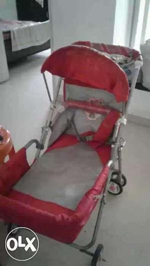 Baby's Red And Gray Stroller