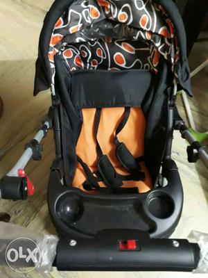 Black, Orange, And White Fabric Stroller