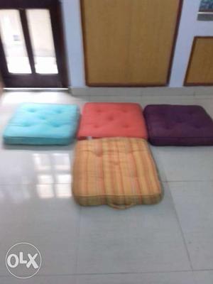 Four Blue, Red, Purple, And Brown Sofa Pillows
