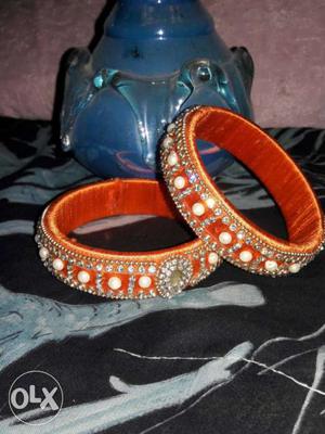 Pair Of Orange And Silver Bangles