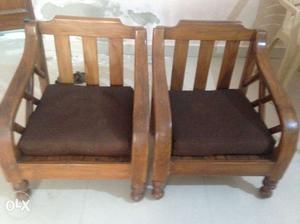 Two Brown Wooden Framed Brown Padded Chairs