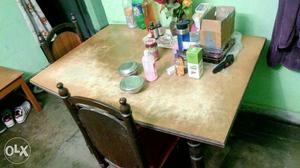 Wooden dining table with four chairs