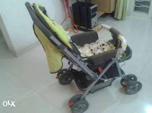 Baby's Grey And Green Stroller
