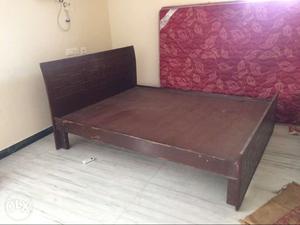 Queen size cot made of solid wood.