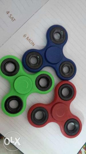 Three Blue-green-and-red 3-bladed Fidget Spinners