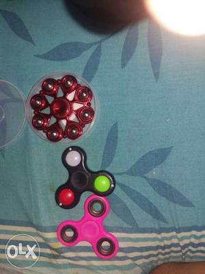 Three Red, Black, And Pink Fidget Spinners