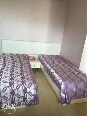 2 single white bed with a drawer set. In very