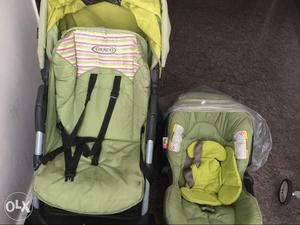 Baby's Green And Black Stroller With Infant Seat Carrier