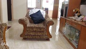Brown Armchair With Black Throw Pillow