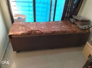 Brown Wooden Base Daybed with mattress and cusions..