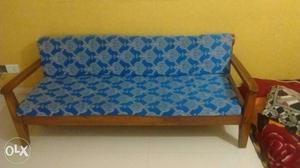 Brown Wooden Framed Futon With Blue Cushion