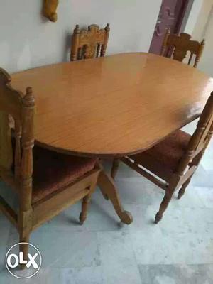 Brown Wooden Table With Padded Chairs Set