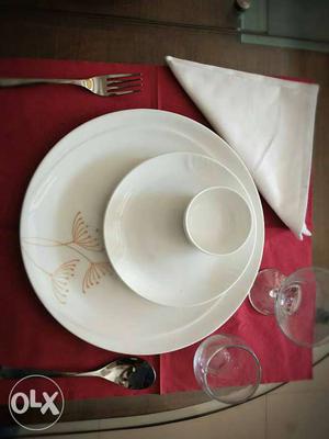 Round White Ceramic Plates And Bowls With Spoon And Fork