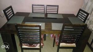 Heavy wooden dining table with 6 chairs. Selling for