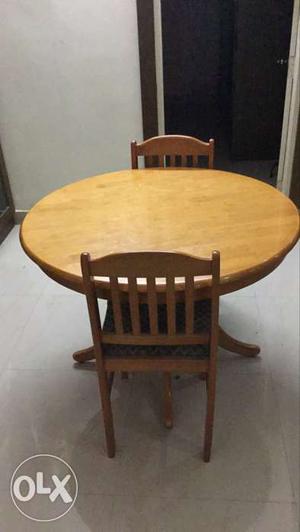 Round Brown Wooden Table With Two Chairs