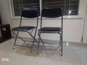 Two Black Leather Steel Folding Chairs