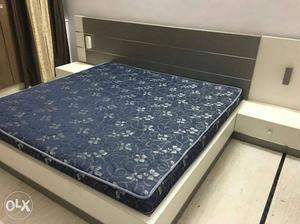 White And Black Wooden Bed With Blue And White Floral Print