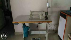 White Electric Sewing Machine With White Wooden Base
