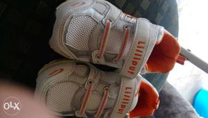 Pair Of White-and-orange Velcro Shoes