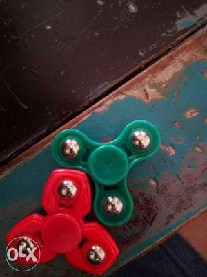 Two Red And Green Fidget Spinnesr