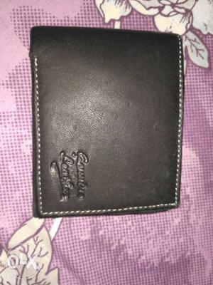 Black coloured leather men's purse.