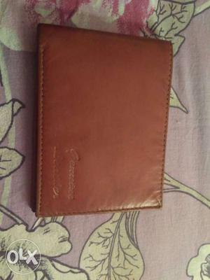 Brown coloured leather purse.