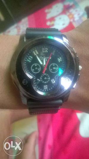 Round Silver Chronograph Watch With Black Rubber Strap