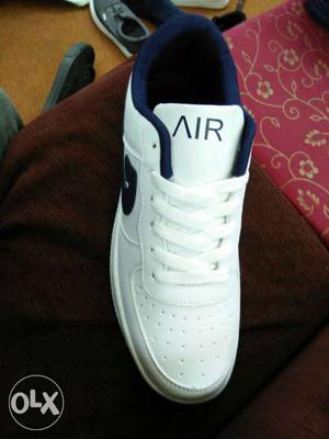 paired White Nike Air Low Top Shoe