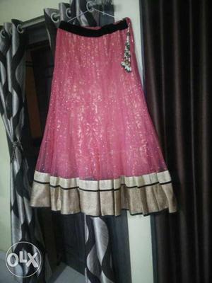 An elegant pink and rose gold lehenga with a