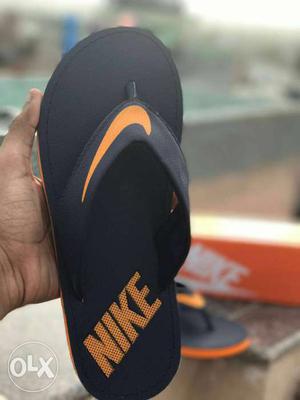 Black-and-orange Nike Flipflops
