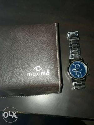 Brown Maxima Leather Wallet; Round Silver Chronograph Watch
