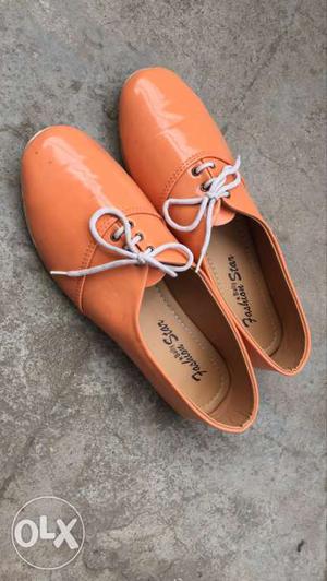 Pair Of Orange Leather Dress Shoes