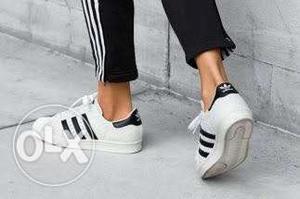 Pair Of White And Black Adidas Superstar