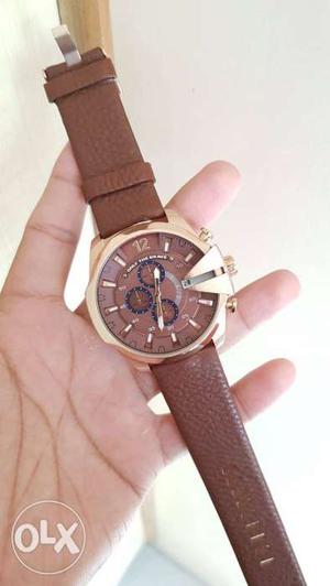 Round Gold Chronograph Watch With Brown Strap