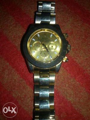 Round Gold Rolex Chronograph Watch With Silver Link Bracelet
