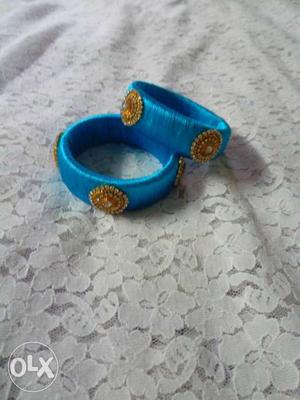 Two Blue-and-gold Pendant Silk Threaded Bangles
