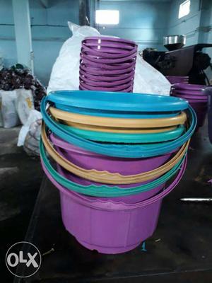 Blue, Yellow, Teal, And Pink Plastic Pails