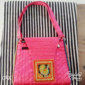 Women's Pink Kutchhi work handbag.