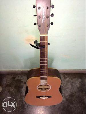 Brown Dreadnought Acoustic Guitar With Black Capo