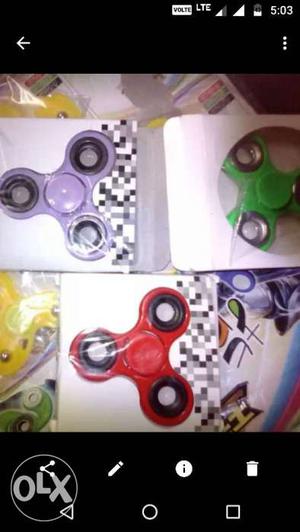 Three Purple, Red And Green Tri-spinner Fidget Toy In Case