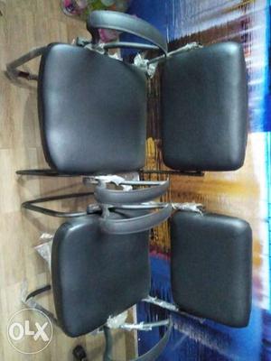 Two Black Padded Metal Armchairs