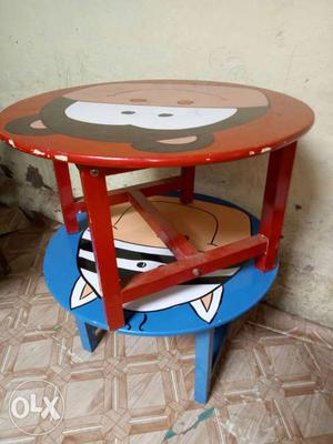Two Round Red And Blue Wooden Tables