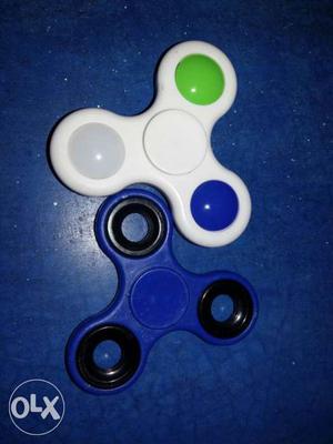 White, Black, Blue, And Green Hand Spinners