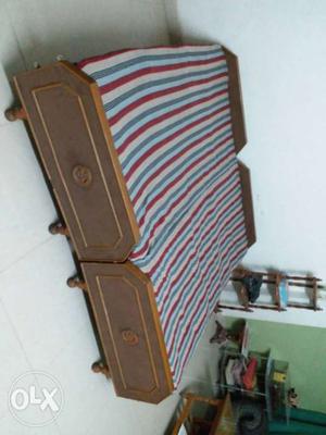 Double bed with mattress and cover.